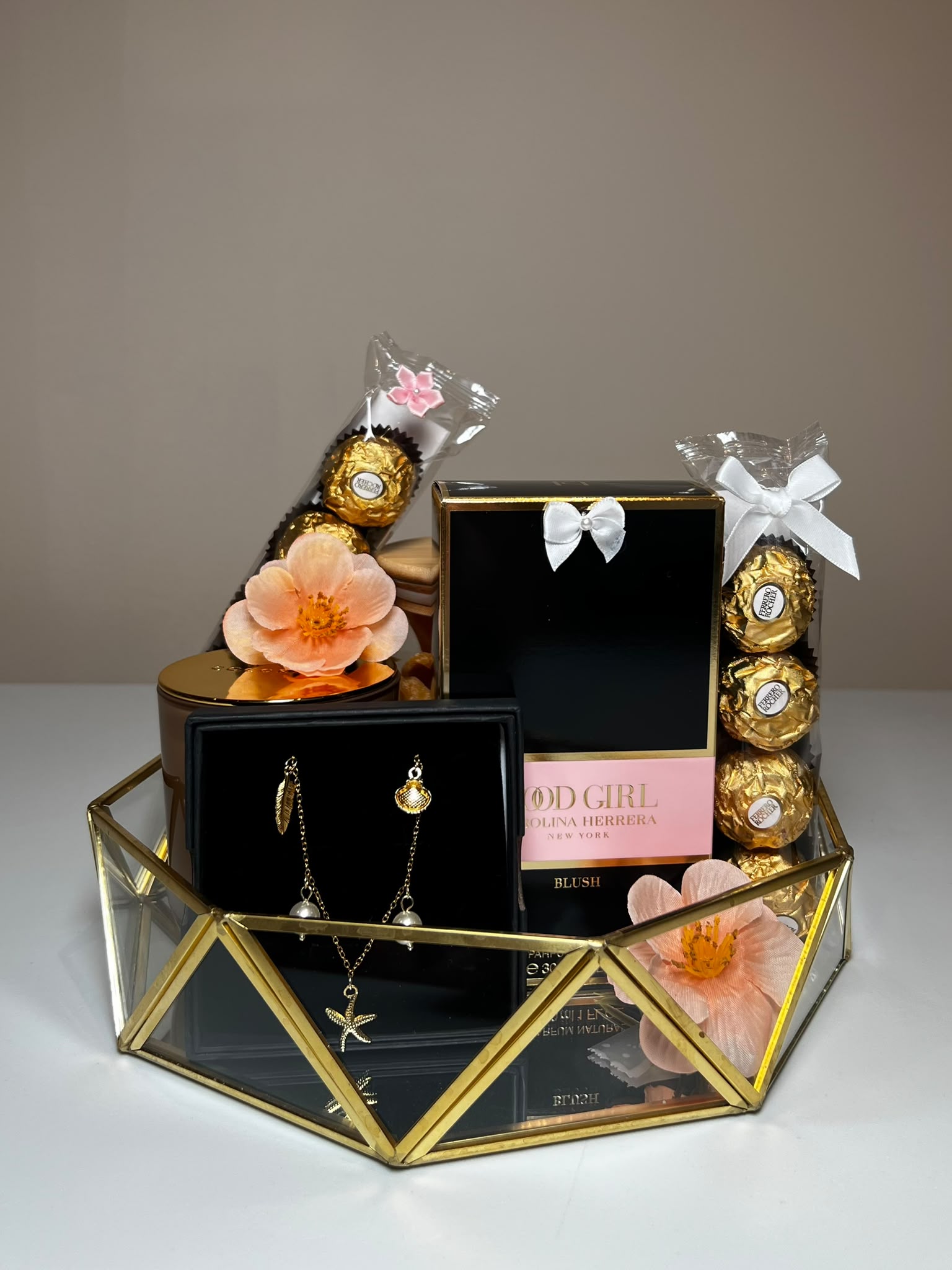 A luxury Classic Bow gift basket with designer perfume, gold jewellery, Ferrero Rocher and blossoms